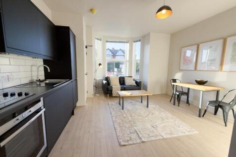 Bright, modern open-plan living area with a fit...