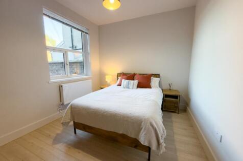 Bright, neatly presented bedroom with a double ...