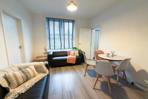 Bright, modern living room with two comfortable...