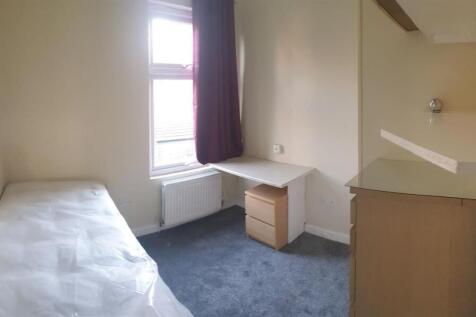 Bright, simply furnished single bedroom with a ...