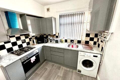 Modern fitted kitchen with grey cabinets, check...