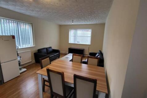 Bright, well-kept living area with a dining tab...