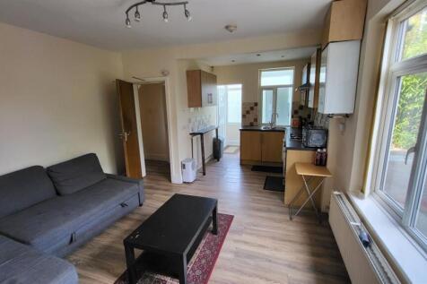 A bright and tidy living room with ample natura...