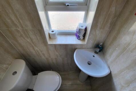 A neat and tidy single toilet space featuring a...