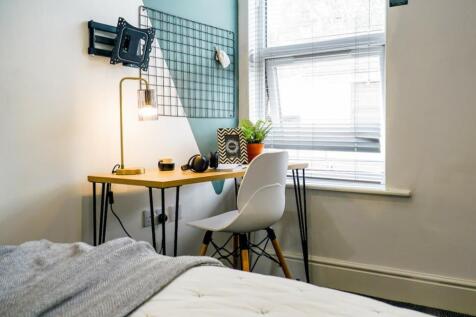 A bright and stylish double bedroom featuring a...