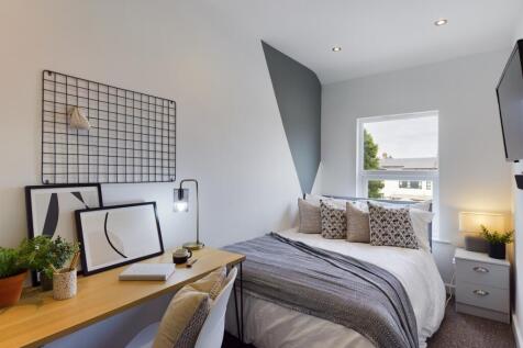 A stylish and well-lit double bedroom with mode...