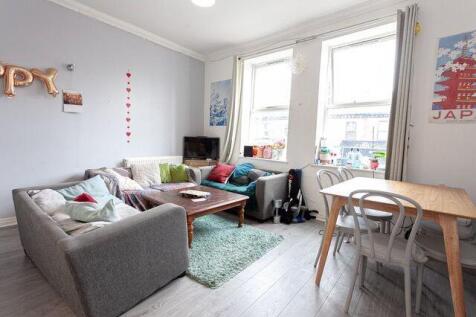 A bright and cozy living room featuring a comfo...