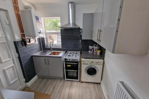 Bright and tidy kitchen featuring modern applia...