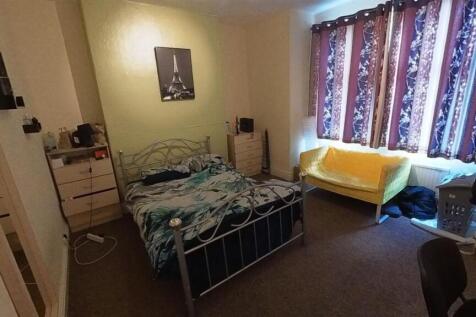 A cozy double bedroom featuring a metal double ...