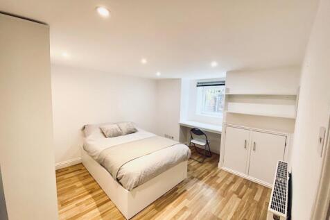 Bright, neatly presented bedroom with a double ...