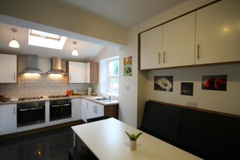 Bright modern kitchen with integrated appliance...