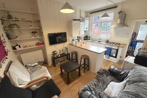 Bright open-plan living area with comfortable s...