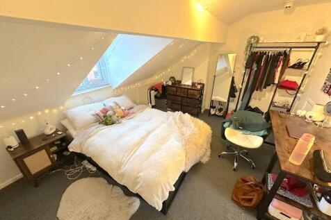 Cozy attic double bedroom with a comfy bed bene...