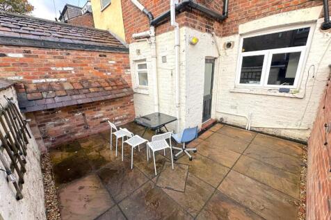 Private paved rear courtyard with simple outdoo...