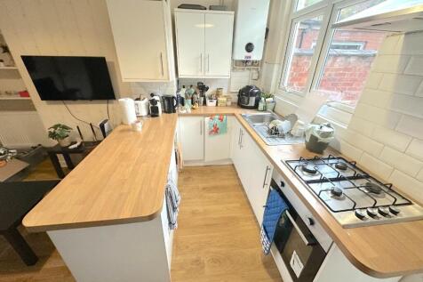 Bright modern kitchen with wooden worktops, int...