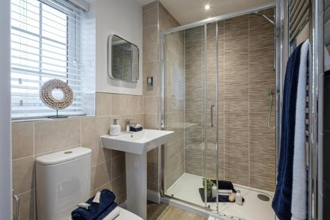 Beige tiled shower room