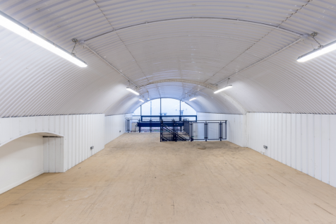 The mezzanine level of an arch with white lining.