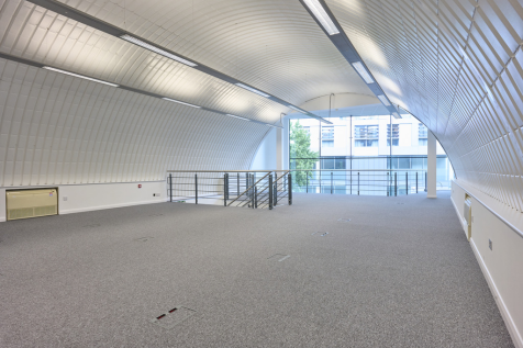 The mezzanine level of an arch with white lining.