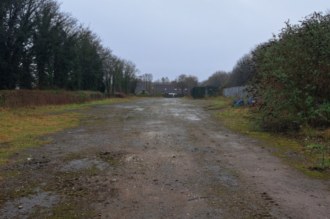 A large plot of land, with fencing around it.