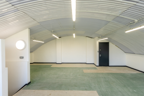 The mezzanine level of an arch, with carpet and lined white.