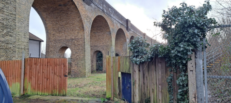 An open yard with metal fencing around it.