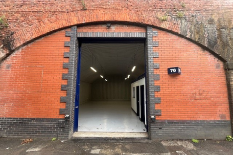 The front of an arch with a metal concertina door pulled back fully.