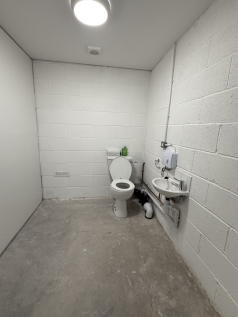 An empty arch with lining and a WC cubicle to the back