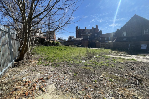 An open yard with metal fencing around it.