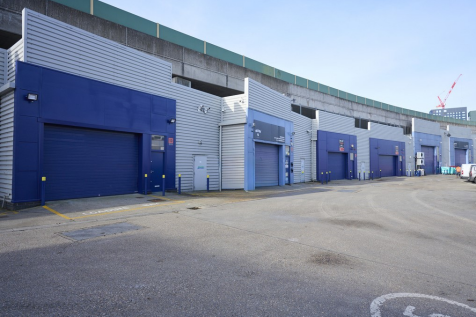 An estate, with multiple warehouse units next to each other. The arches have closed electric roller shutter entrances.