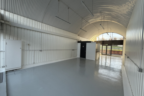 The ground floor of an arch, suitable to use as an office unit, with glazing at the front.