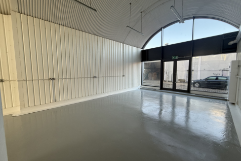 An empty arch with lining and full height glazing to the front