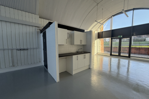 An empty arch with lining and full height glazing to the front