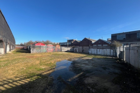 An open yard with metal fencing around it.