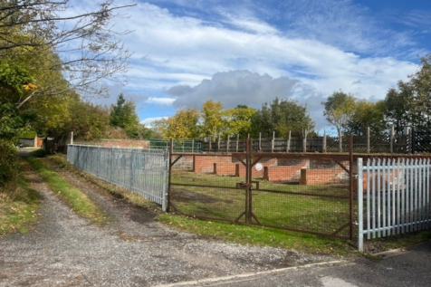 A large plot of land, with fencing around it.