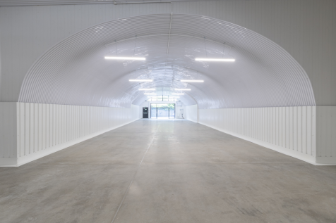 An empty arch with lining and full height glazing to the front