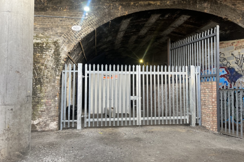 An open yard with metal fencing around it.