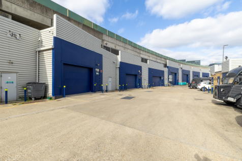 An estate, with multiple warehouse units next to each other. The arches have closed electric roller shutter entrances.