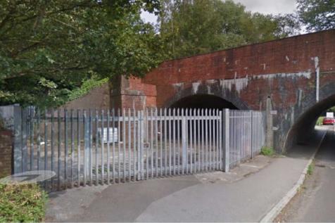 A large plot of land, with fencing around it.