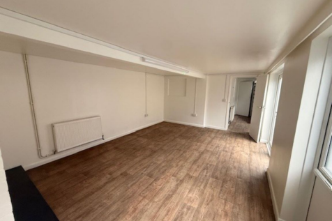 The front of an arch, with glazing on the bottom half and door allowing you to see into the arch interior.