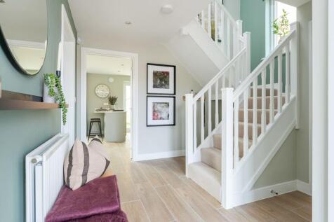 A welcoming entrance hall with feature staircase