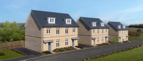 Three modern semi-detached houses with brick facades, dark roofs, and white window frames in a new r