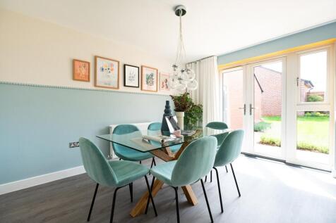 The dining area has double doors out to the garden, flooding the room with natural light