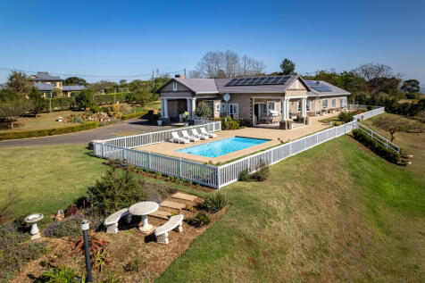 Main home boasting sparkling pool and full solar