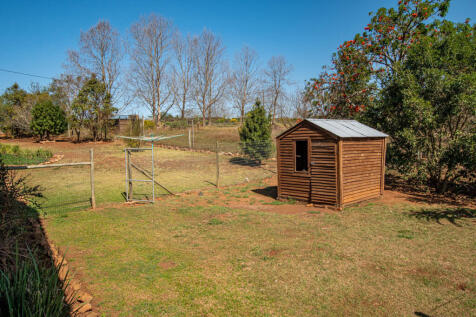 Chicken coop set on ample grazing land for other animals