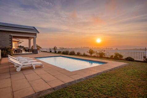 Main home and sparkling pool from another angle