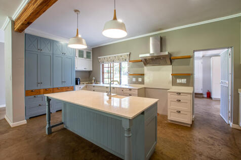 a country style kitchen with plenty of cupboard space