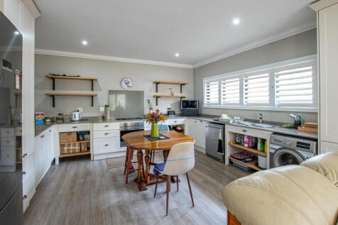 Cottage - Large open plan kitchen with Plantation security shutters