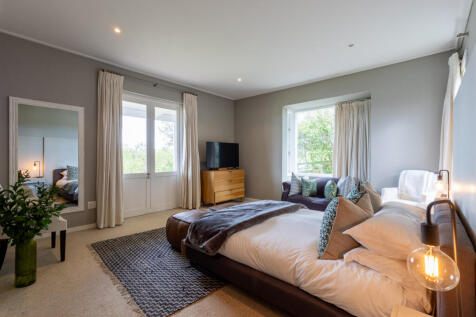 Main bedroom with doors to the patio overlooking the dam