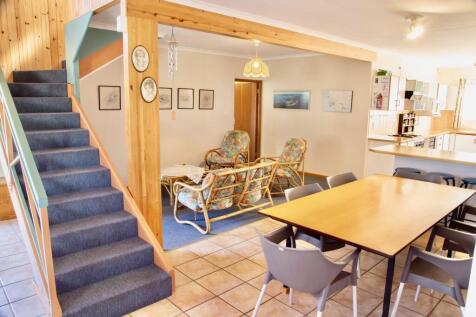 Stairs to 1st floor with tv room tucked underneath