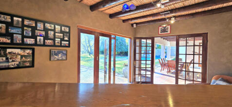 ENTERTAINMENT ROOM WITH DOORS OPEN ONTO THE GARDEN
